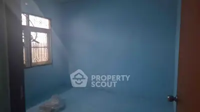 Empty blue room with window and door, ideal for customization