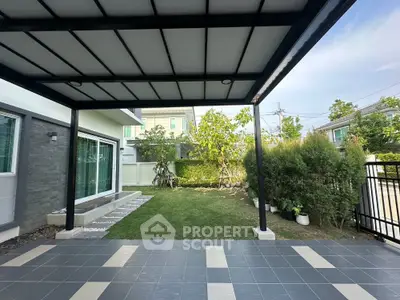 Modern home with covered patio and lush garden in serene neighborhood