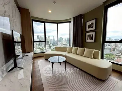 Luxurious living room with panoramic city views and modern furnishings in high-rise apartment.
