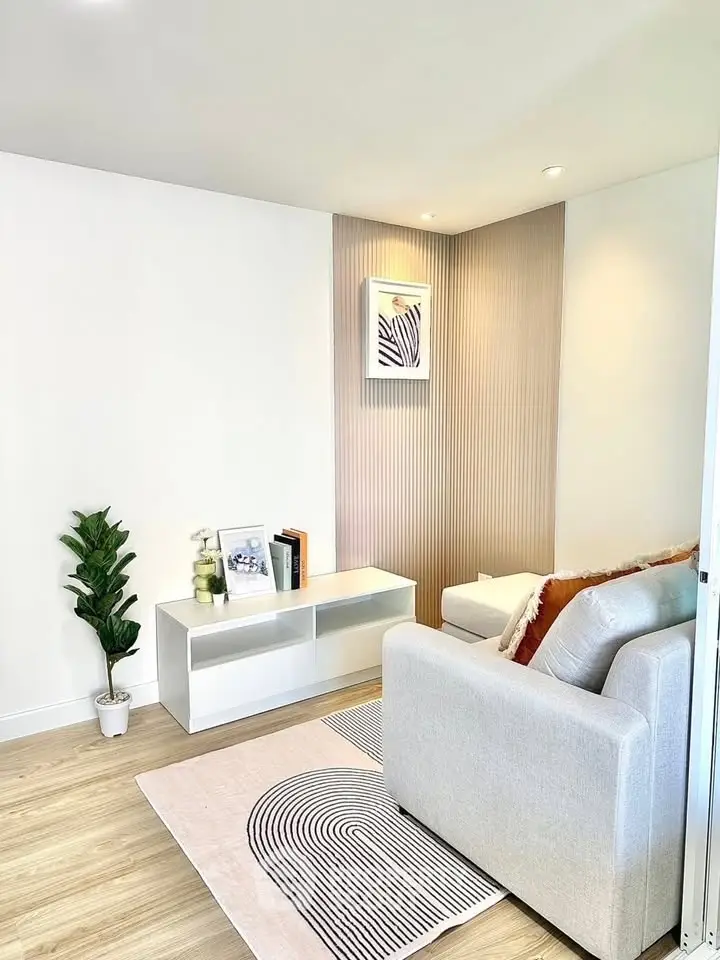 Modern living room with stylish decor and cozy seating area, perfect for relaxation.