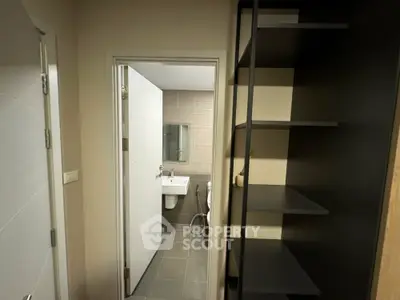 Modern bathroom with sleek shelving and minimalist design