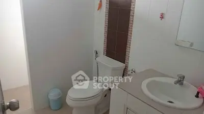 Modern bathroom with sleek fixtures and tiled walls, perfect for a contemporary home.