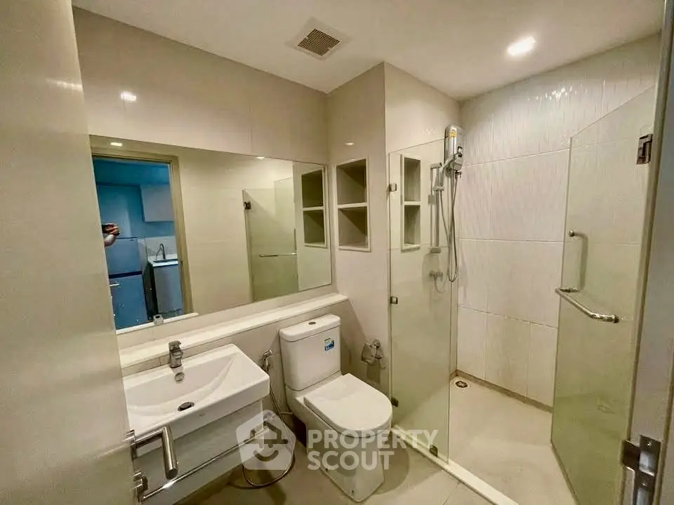 Modern bathroom with glass shower and sleek fixtures
