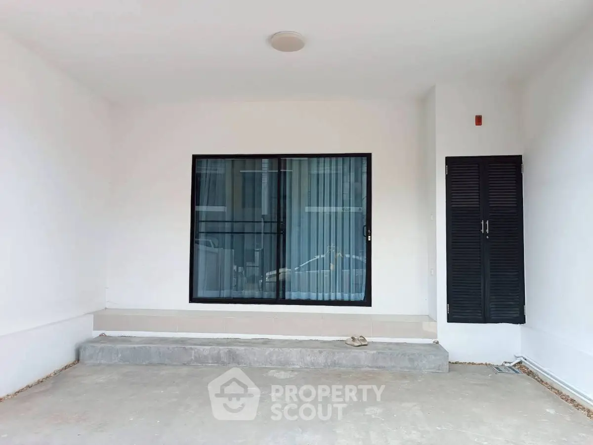 Minimalist exterior with sliding glass door and shuttered window