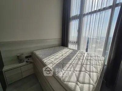 Bright bedroom with large window and modern furnishings