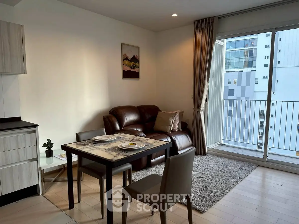 Modern living room with balcony view and cozy dining area