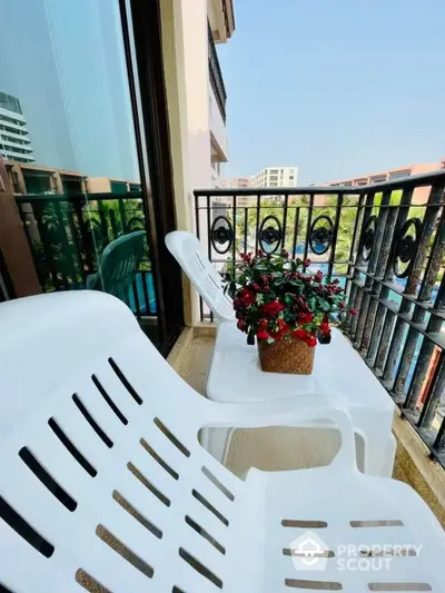 Charming balcony with seating and potted plant overlooking scenic view