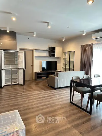 Modern living room with open layout, stylish furniture, and natural light.