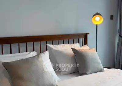 Cozy bedroom with stylish wooden headboard and modern floor lamp