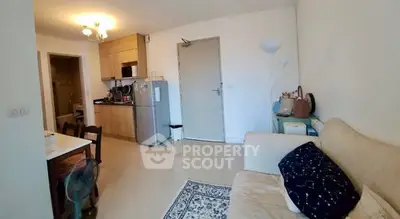 Cozy living room with open kitchen layout and modern furnishings