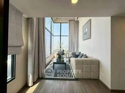 Luxurious living room with floor-to-ceiling windows and stunning city view
