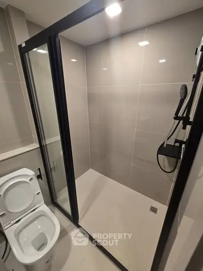 Modern bathroom with sleek shower enclosure and contemporary fixtures.