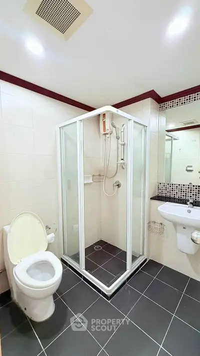 Modern bathroom with glass shower enclosure and sleek fixtures