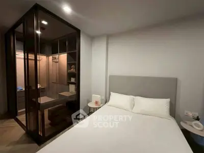 Modern bedroom with glass-enclosed walk-in closet and minimalist decor