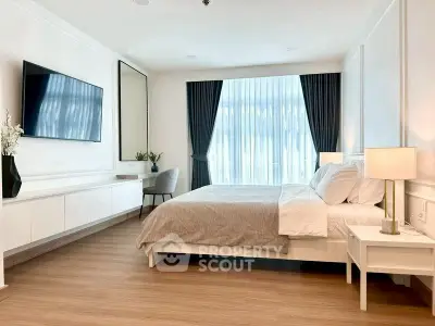 Luxurious bedroom with modern decor, large window, and stylish furnishings in a high-end apartment.