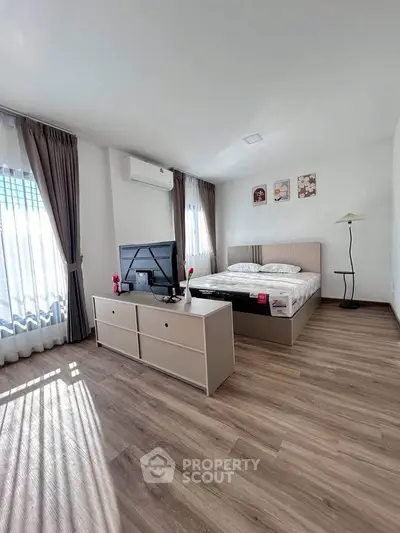 Spacious bedroom with modern decor and natural light