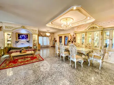 Luxurious living room with ornate furniture and elegant decor, featuring a spacious layout and exquisite ceiling design.