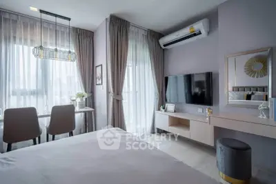 Modern bedroom with stylish decor, featuring a wall-mounted TV, air conditioning, and elegant curtains.