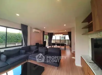 Spacious modern living room with elegant dining area and large windows