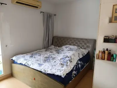Cozy bedroom with stylish bed and air conditioning, perfect for restful nights.