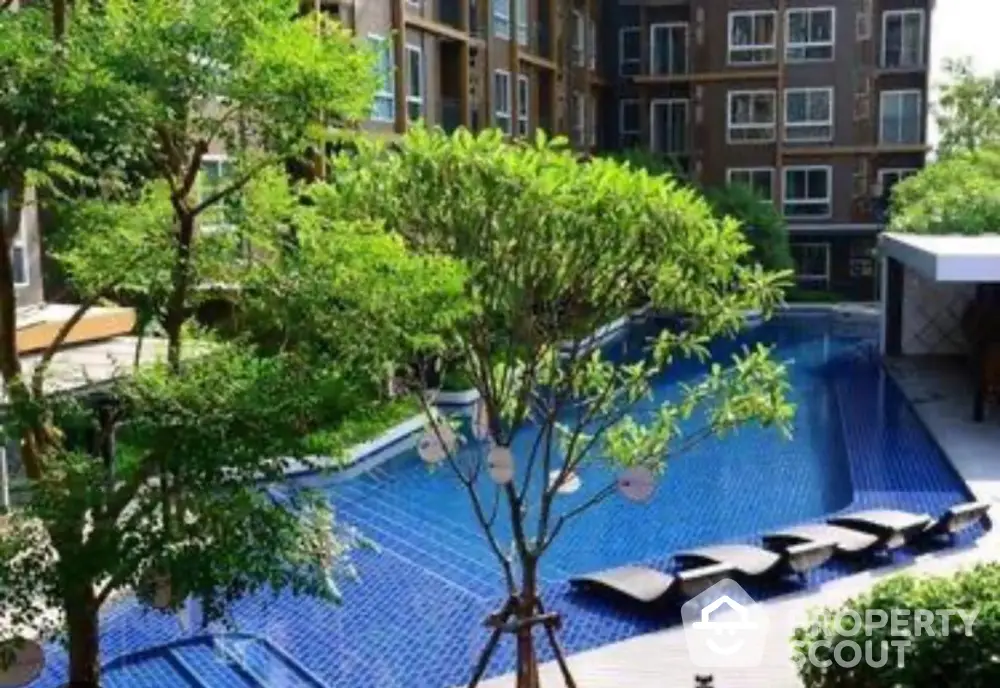 Luxurious residential complex with stunning outdoor pool and lush greenery