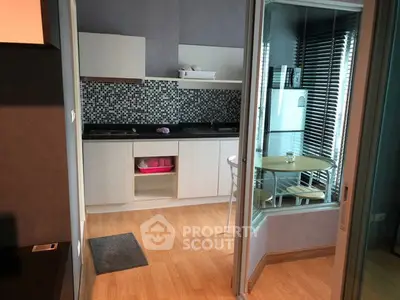 Modern kitchen with open layout and stylish backsplash in cozy apartment.