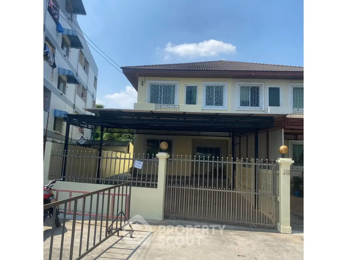 Charming two-story house with gated entrance and spacious driveway