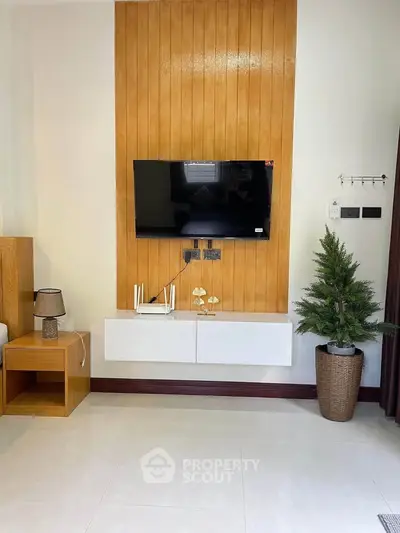 Modern living room with wall-mounted TV and stylish decor