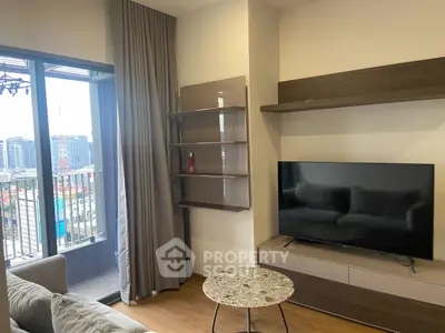 Modern living room with balcony view, featuring sleek TV setup and stylish shelving.