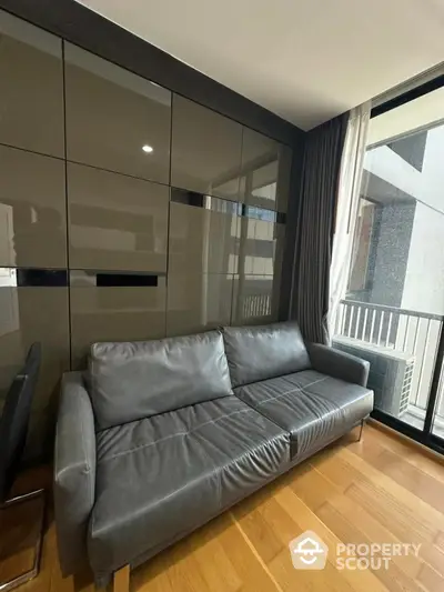 Modern living room with sleek leather sofa and large window view