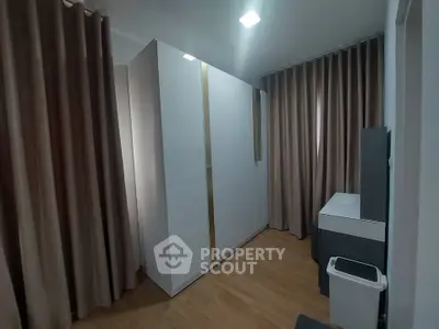 Modern storage room with sleek cabinets and wooden flooring