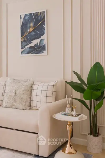 Elegant living room with plush sofa, stylish decor, and indoor plant for a cozy ambiance.