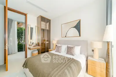 Luxurious bedroom with modern decor and natural light, featuring elegant furniture and stylish artwork.