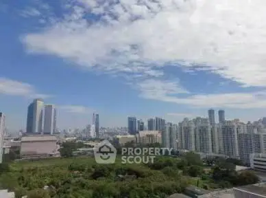 Stunning cityscape view with lush greenery and modern skyscrapers under a vibrant sky.