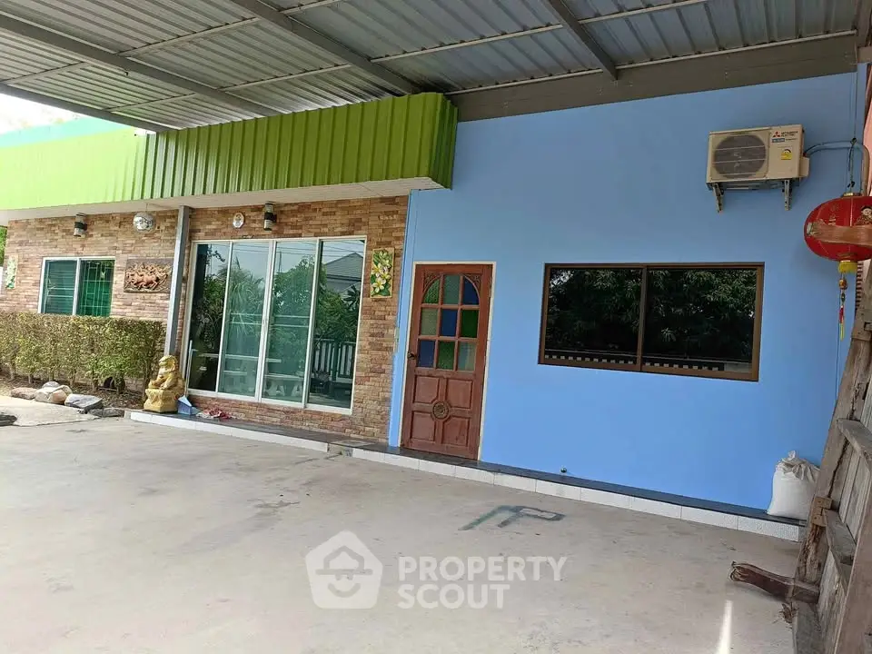 Charming single-story home with vibrant exterior and spacious covered patio.