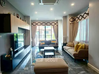 Spacious living room with modern decor and large windows for natural light.