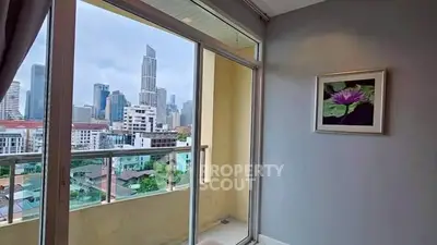 Modern apartment balcony with stunning city skyline view, perfect for urban living.