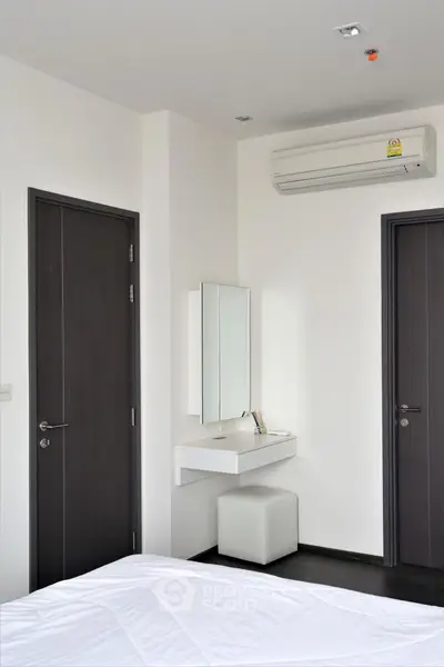 Modern bedroom with minimalist decor and air conditioning unit