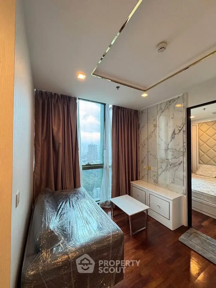 Modern apartment interior with wrapped furniture and city view from window