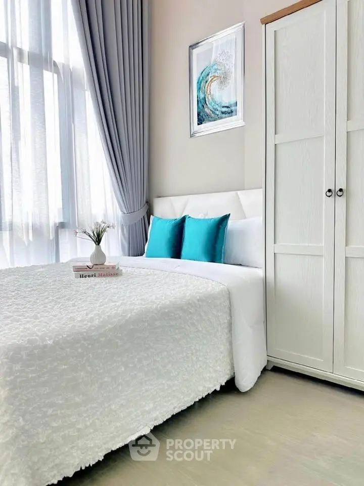 Bright and cozy bedroom with modern decor and ample natural light.