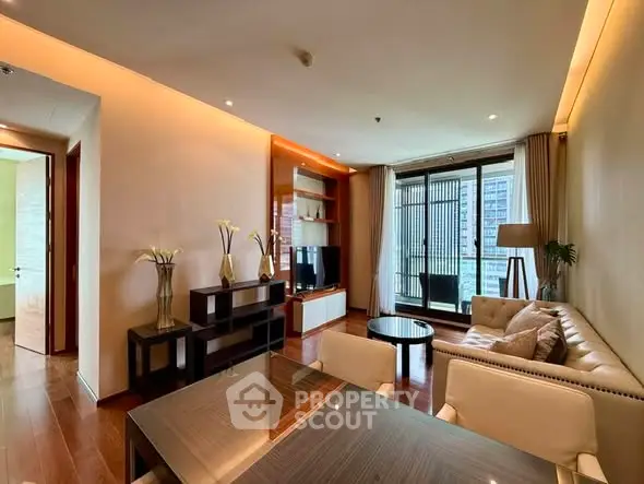 Luxurious living room with modern decor and large windows offering city views.