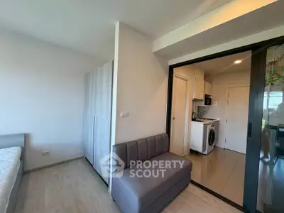Modern studio apartment with compact kitchen and cozy living area