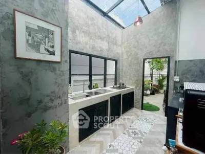 Stylish open kitchen with skylight and modern design elements.