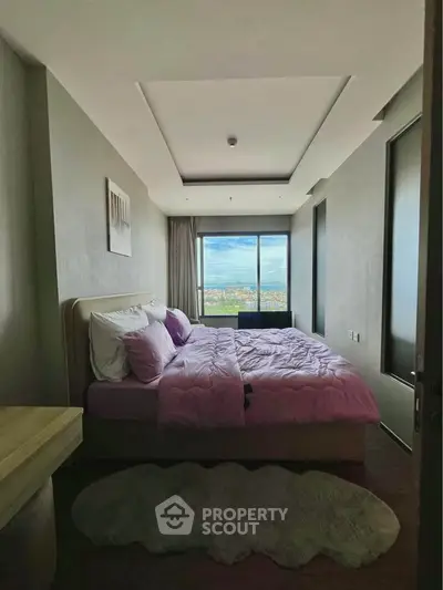 Luxurious bedroom with stunning city view and plush bedding