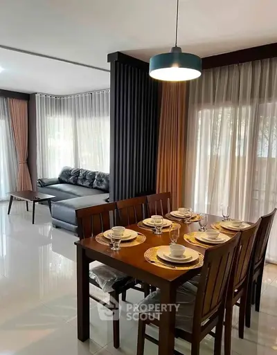 Spacious living and dining area with elegant decor and natural light.
