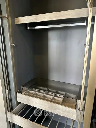 Modern closet with organized shelving and hanging space in luxury home.