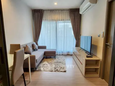 Modern living room with cozy sofa, TV, and large window with curtains in a stylish apartment.