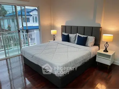 Spacious bedroom with elegant decor and balcony access in modern home