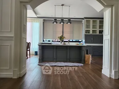 Spacious kitchen with island and modern cabinetry in elegant home.