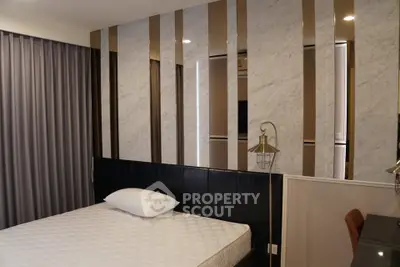 Modern bedroom with stylish accent wall and comfortable mattress in a contemporary apartment.